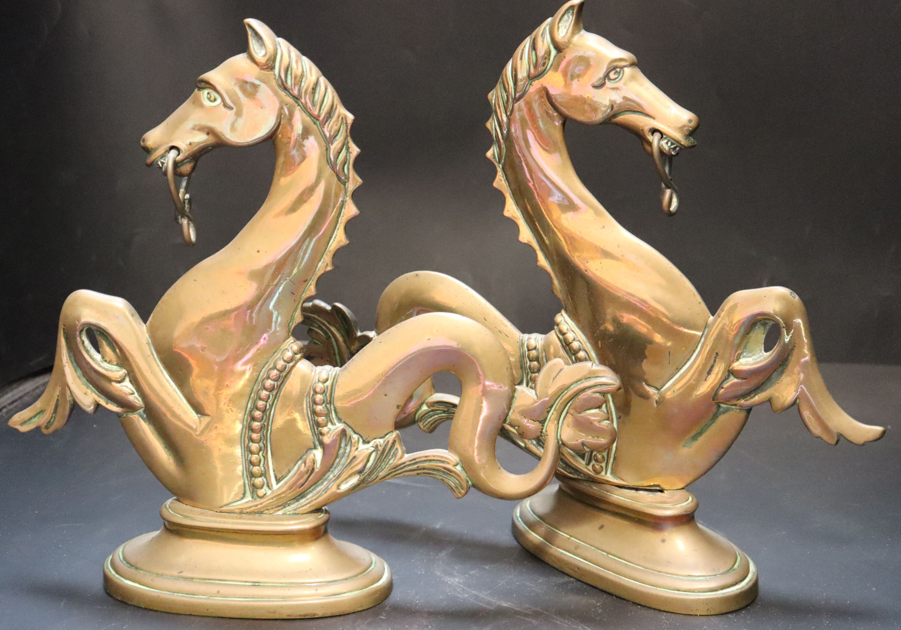 A pair of Venetian brass seahorse gondola finials, height 31cm